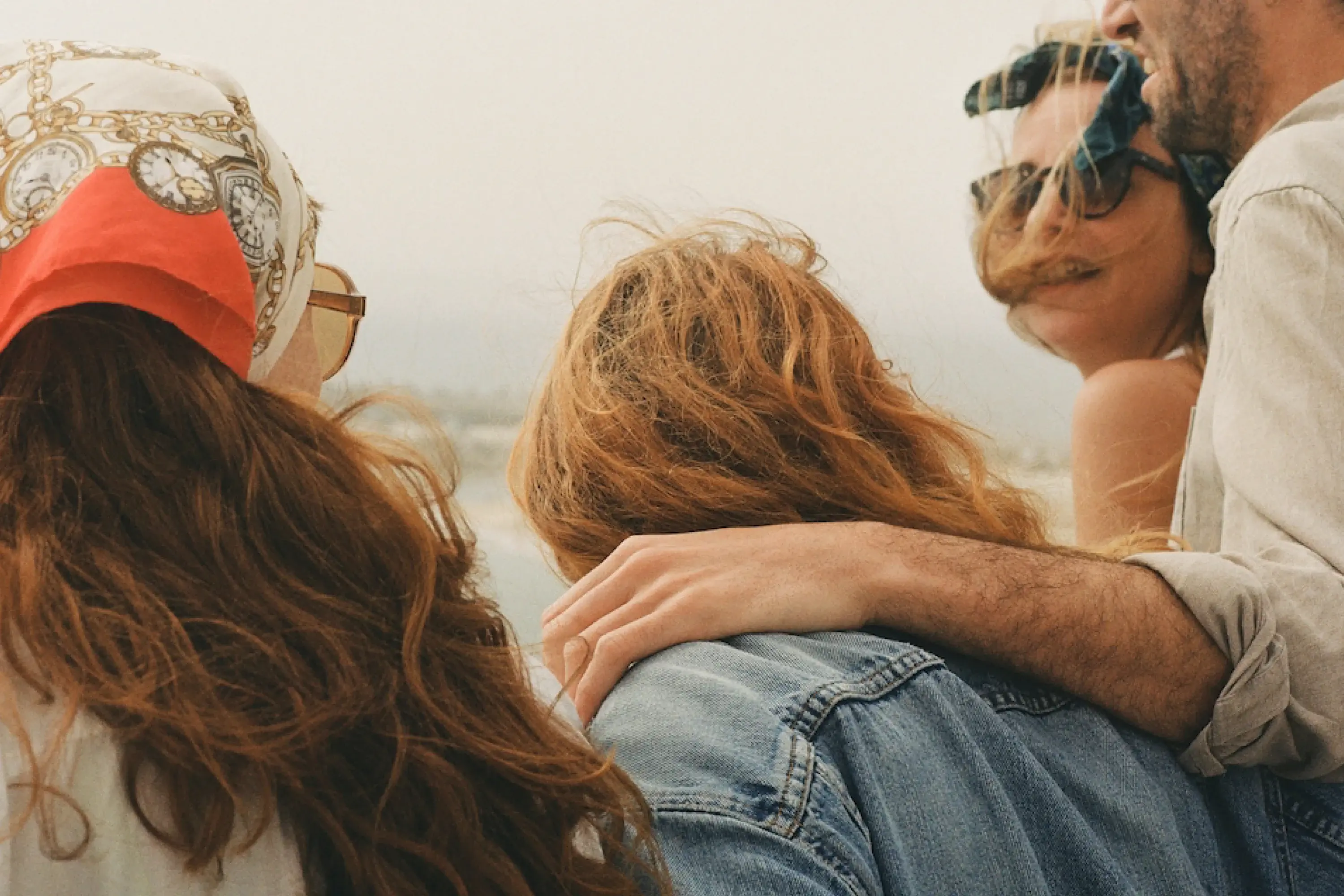 four people next to each other talking 